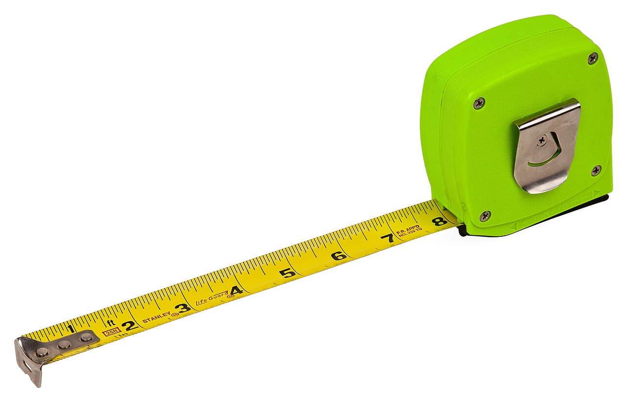 A lime-green tape measure with its yellow blade pulled out to eight inches.